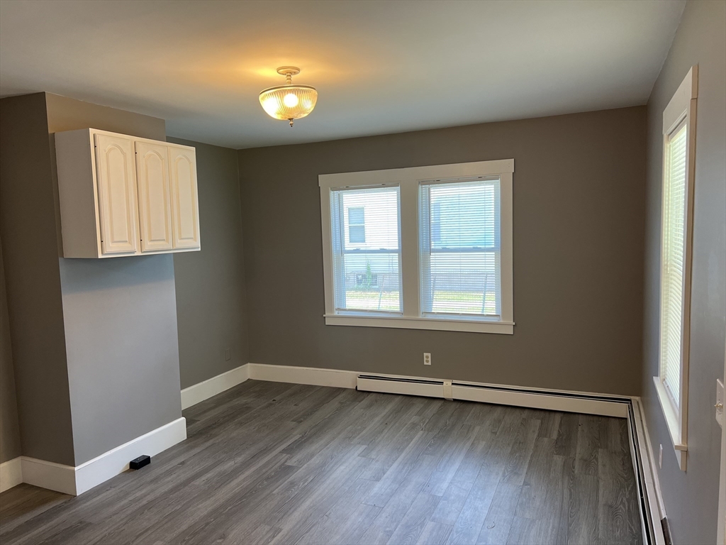 2102-2104 Palmer Road Three Rivers, MA 01080 - Photo 8 of 15 an empty room with window and wooden floor