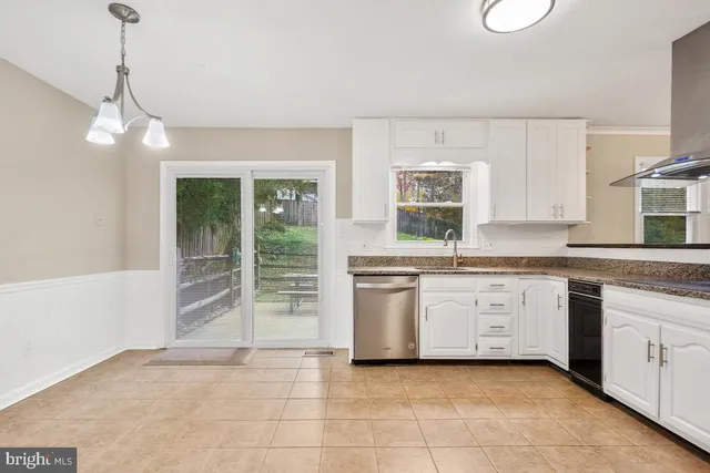 a kitchen with granite countertop a stove a sink and a granite counter tops