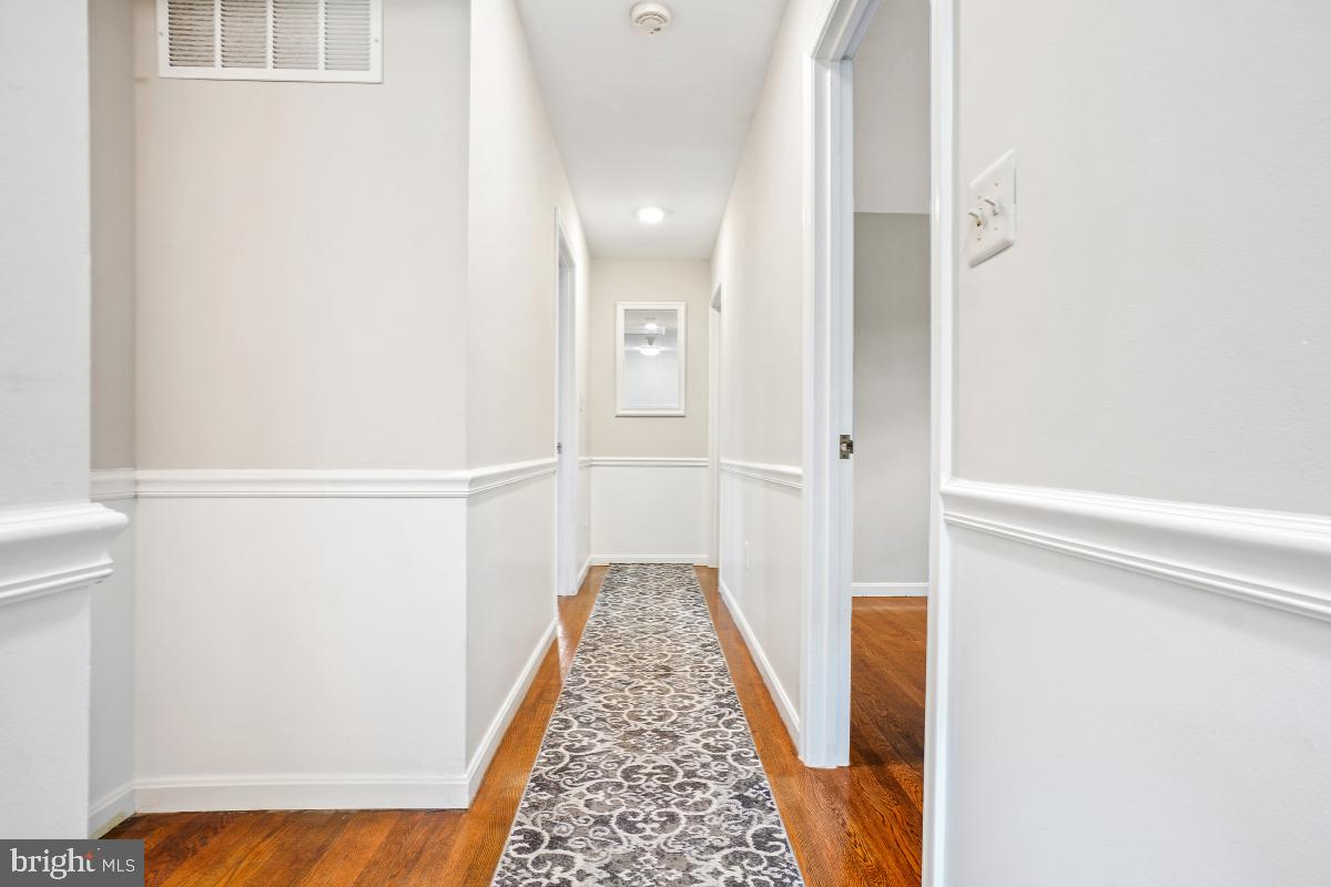 6871 Churchill Road McLean, VA 22101 - Photo 17 of 30 a view of a hallway with wooden floor and staircase