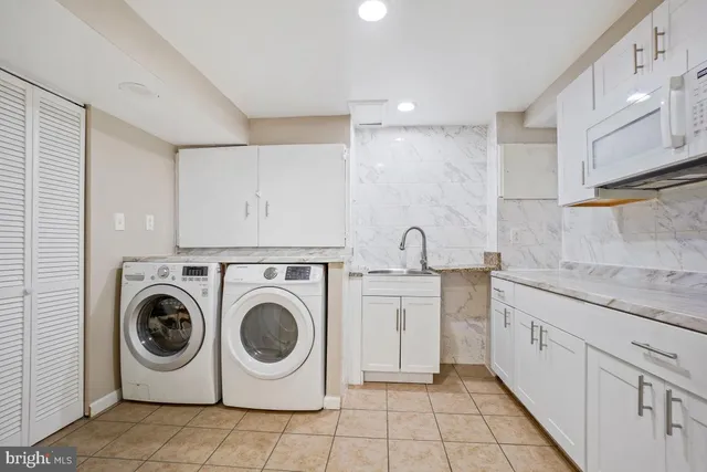 a kitchen with white cabinets and refrigerator