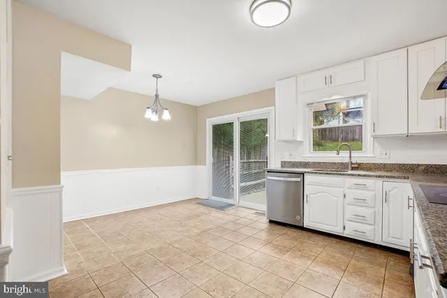 a large white kitchen with a window