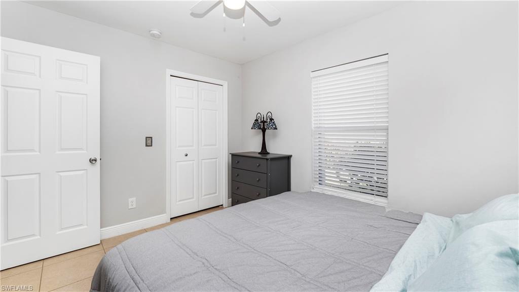 3340 2nd Avenue Southeast Naples, FL 34117 - Photo 15 of 25 a bedroom with a bed and a window