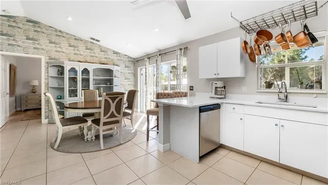 a kitchen with stainless steel appliances a sink and cabinets