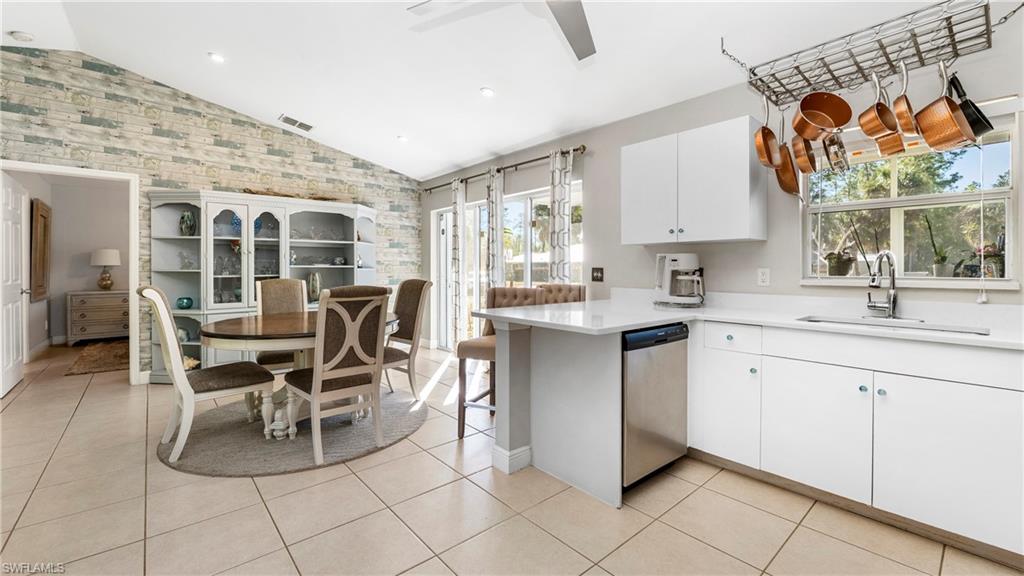 3340 2nd Avenue Southeast Naples, FL 34117 - Photo 3 of 25 a kitchen with stainless steel appliances a sink and cabinets