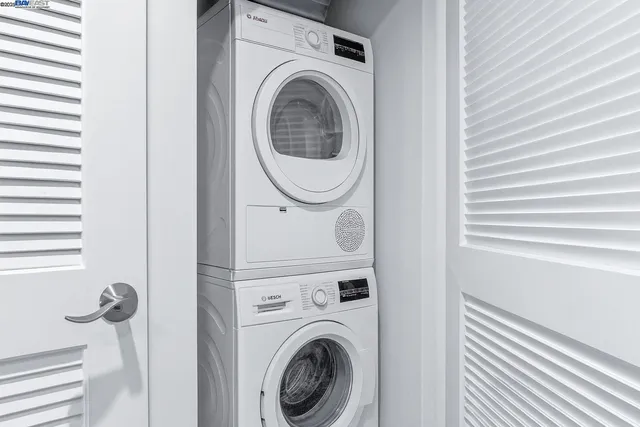 a bedroom with a large bed and a fireplace