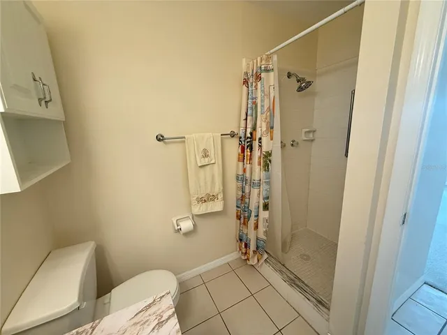 a bathroom with a shower and toilet
