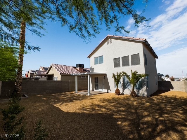 3686 Lincoln Road Las Vegas, NV 89115 - Photo 25 of 26 Rear view of house with a patio, a fenced backyard, a tile roof, and stucco siding