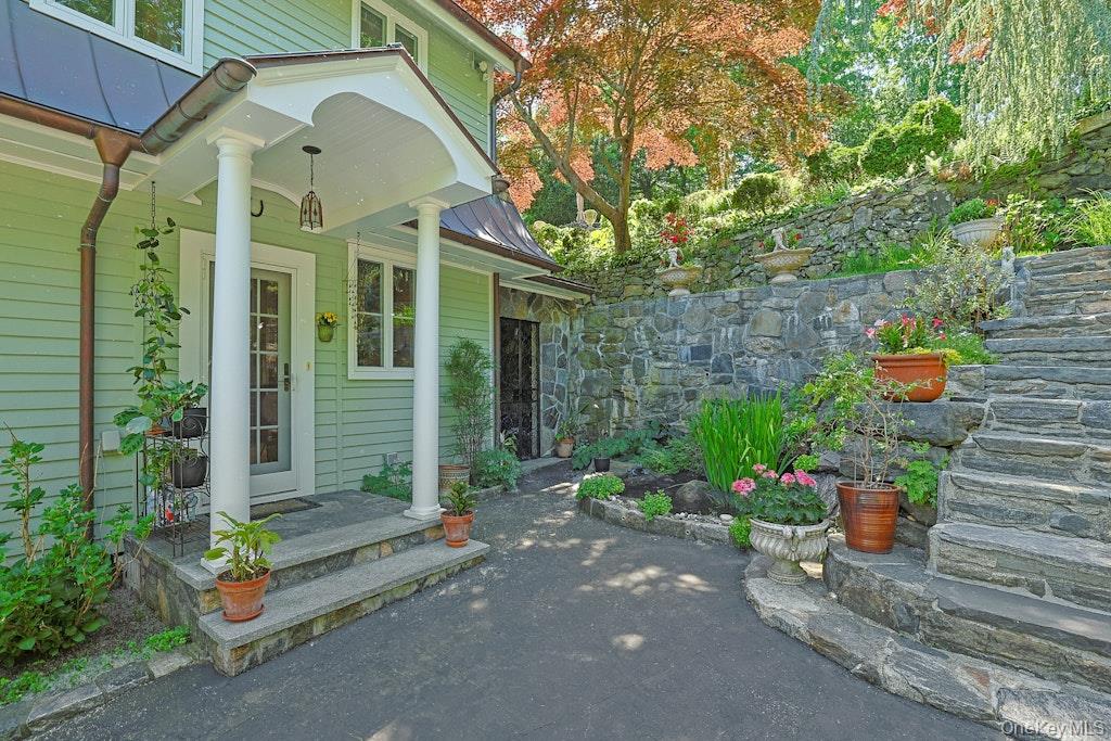 97 Underhill Road Scarsdale, NY 10583 - Photo 24 of 39 a front view of a house with a garden