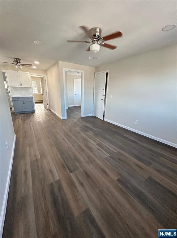 54 Windsor Street, Unit 3 Kearny, NJ 07032 - Photo 1 of 5 a view of empty room with wooden floor and ceiling fan