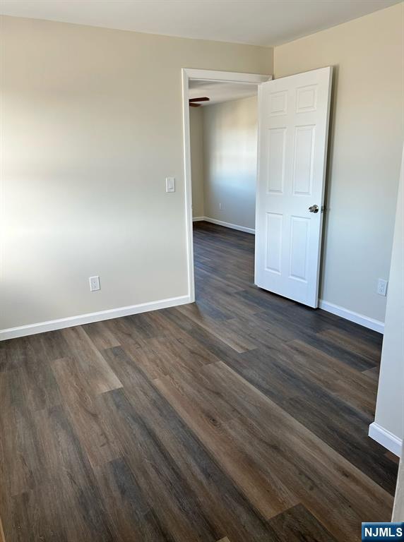 54 Windsor Street, Unit 3 Kearny, NJ 07032 - Photo 3 of 5 an empty room with wooden floor and closet