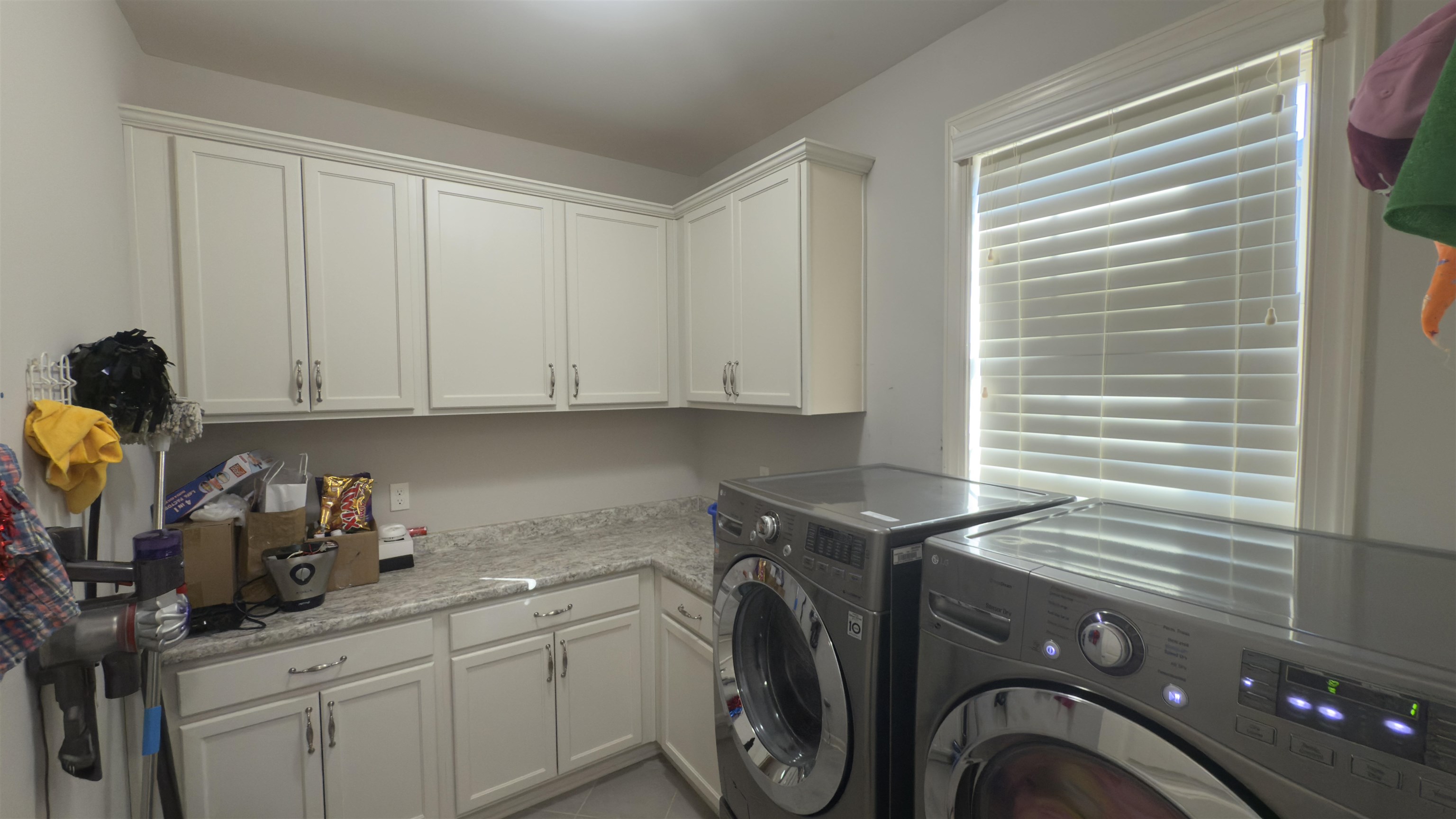 1217 Pilgrim Ridge Road Collierville, TN 38017 - Photo 13 of 33 Laundry area with washing machine and clothes dryer, cabinet space, and light tile patterned floors