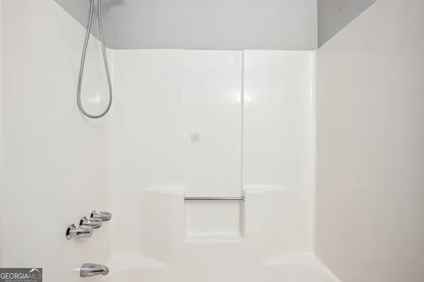 a bathroom with a glass shower door
