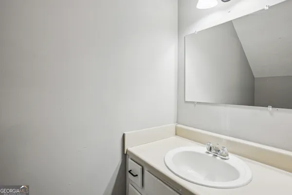 a bathroom with a sink a vanity and a mirror