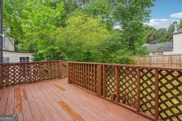 a balcony with wooden floor and fence