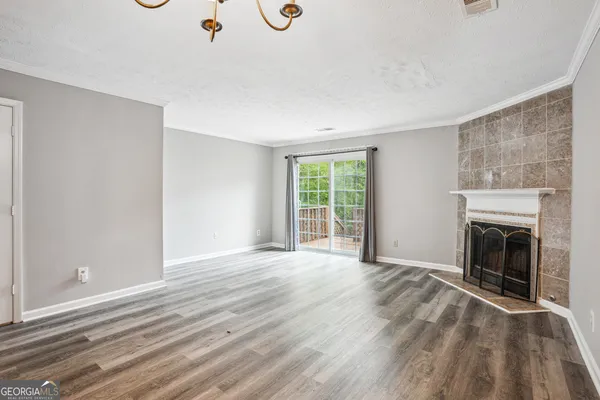 wooden floor fireplace and natural light in room