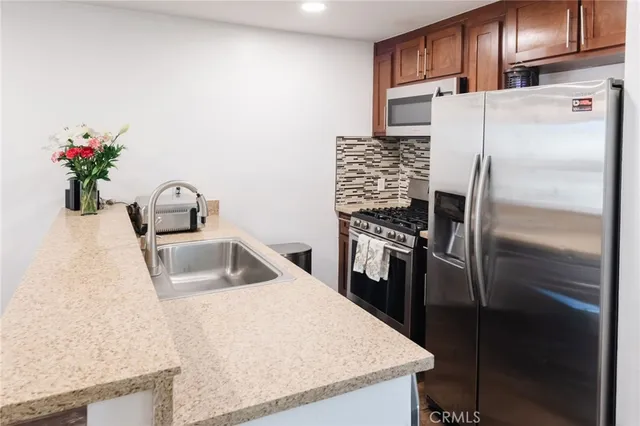 a kitchen with a refrigerator sink and microwave