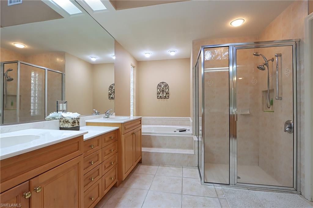 5815 Persimmon Way Naples, FL 34110 - Photo 11 of 24 a spacious bathroom with a shower sink mirror and a bathtub