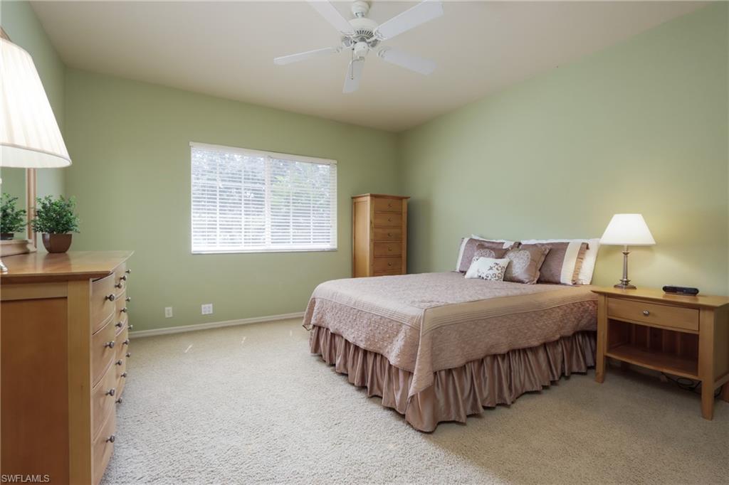 5815 Persimmon Way Naples, FL 34110 - Photo 14 of 24 a bedroom with a bed and a chandelier