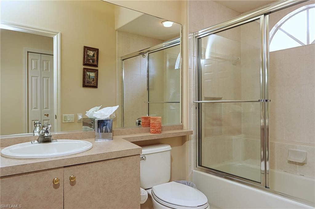 5815 Persimmon Way Naples, FL 34110 - Photo 16 of 24 a bathroom with a sink toilet and shower