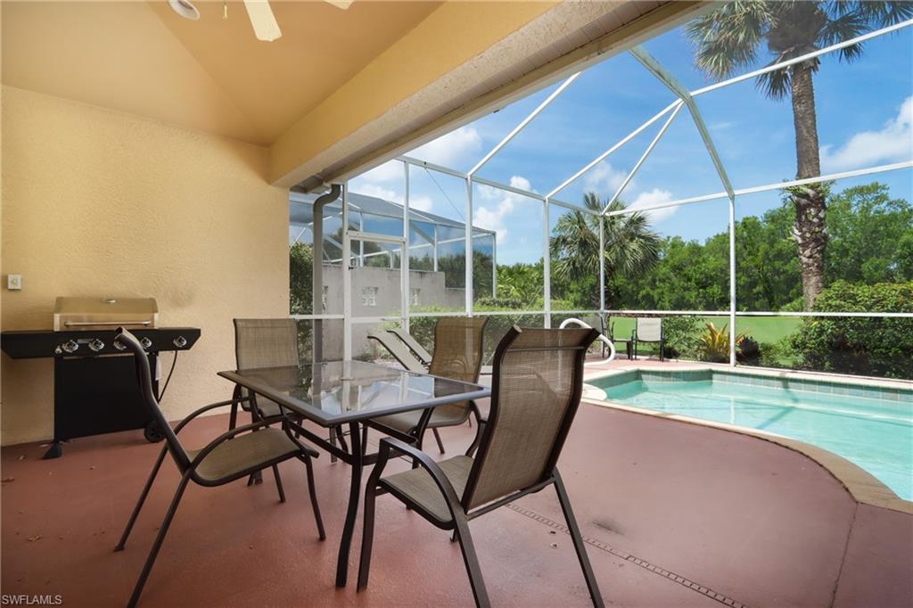 5815 Persimmon Way Naples, FL 34110 - Photo 20 of 24 a view of a chair and table in the patio