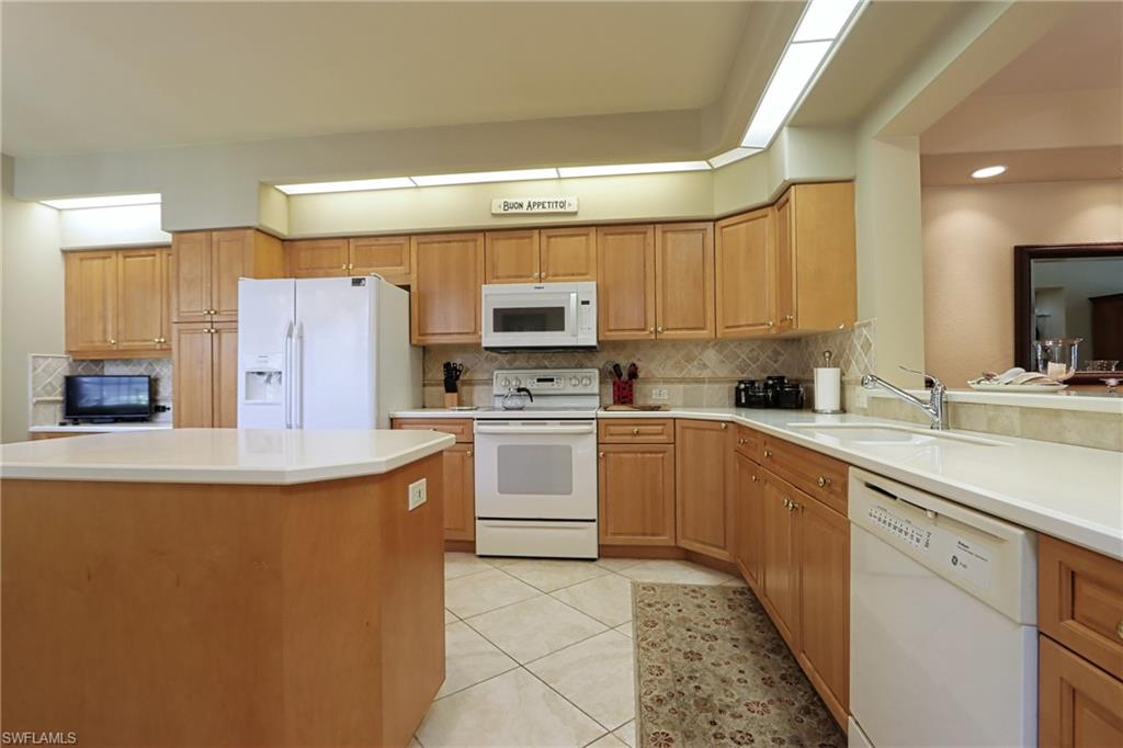 5815 Persimmon Way Naples, FL 34110 - Photo 6 of 24 a kitchen with stainless steel appliances a refrigerator sink and microwave