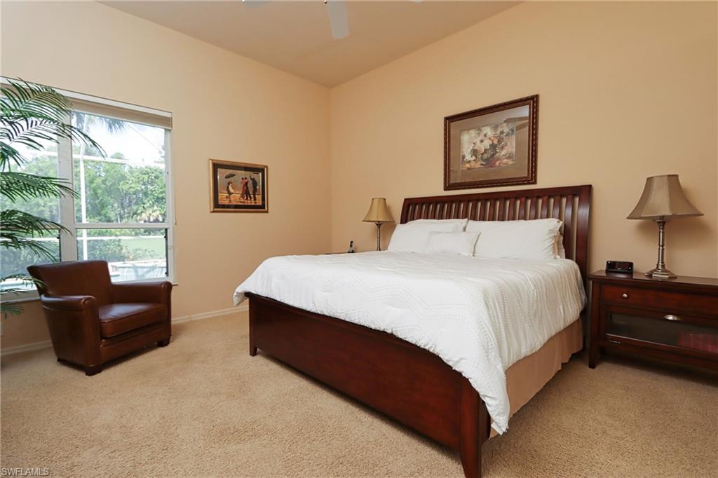 5815 Persimmon Way Naples, FL 34110 - Photo 10 of 24 a bedroom with a bed and a couch with window