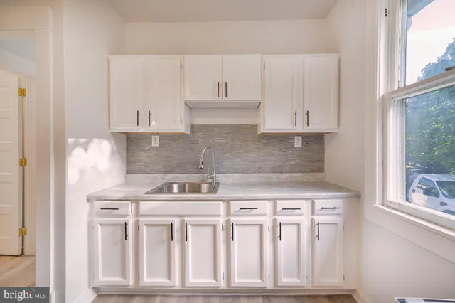 a bathroom with a sink a toilet a shower and a mirror