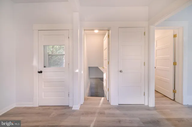 a view of a hallway with wooden floor