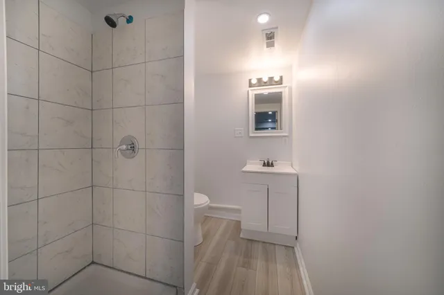 a bedroom with a bed and a potted plant