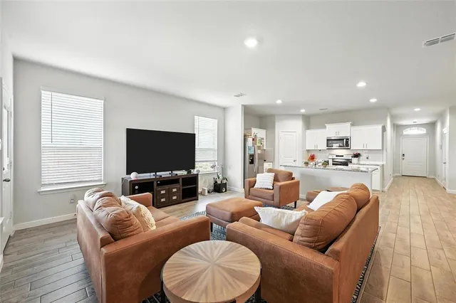 a large kitchen with a table and chairs