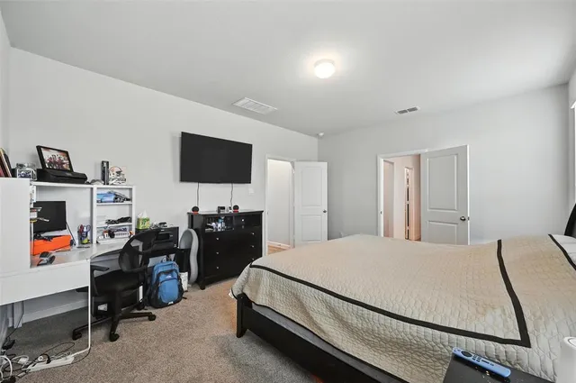 a living room with furniture and a view of kitchen