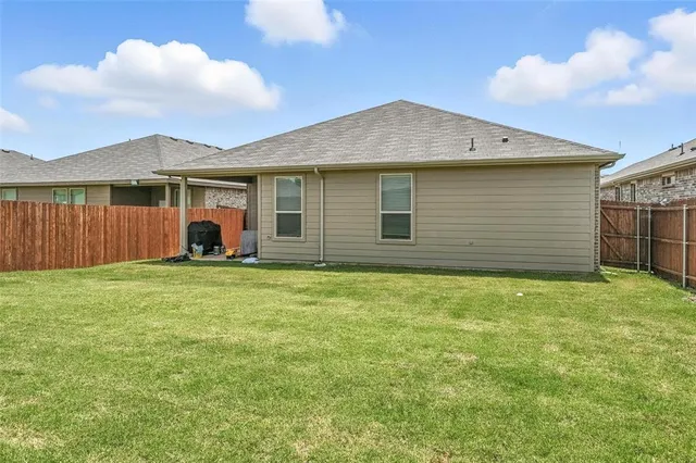 a bathroom with a sink a toilet and shower curtain