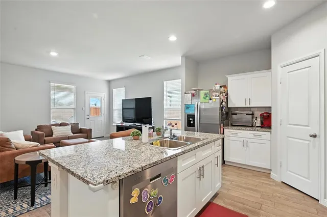 a front view of a house with a garden and yard