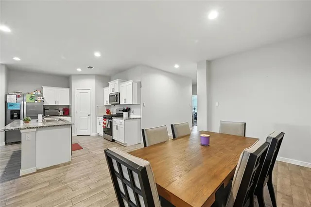 a view of a dining room with furniture and wooden floor