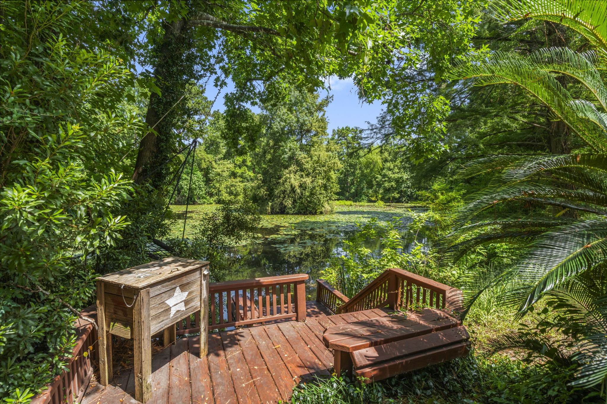 426 Nursery Road The Woodlands, TX 77380 - Photo 35 of 41 Awesome custom built-in deck with railing, bench seating, cooler, leads to pond - great for fishing.