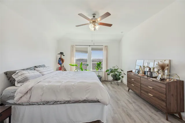 a bed room with a bed and a chandelier