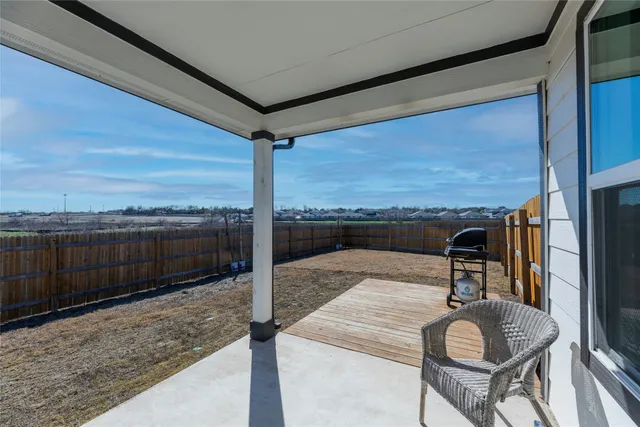 a view of a balcony with furniture and city view