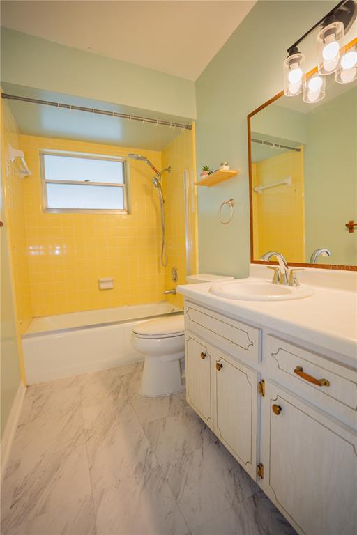 417 L Lanier Road Fort Meade, FL 33841 - Photo 11 of 36 a bathroom with a granite countertop sink and a bathtub