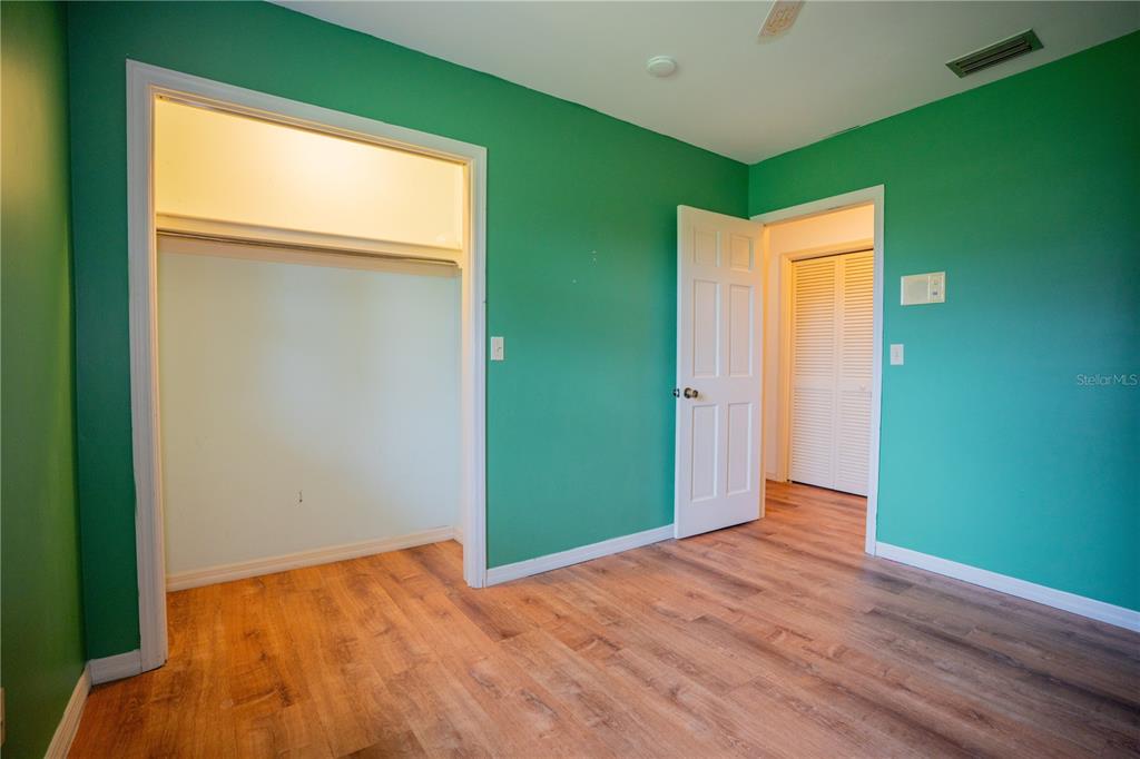 417 L Lanier Road Fort Meade, FL 33841 - Photo 12 of 36 a view of an empty room with wooden floor and a window