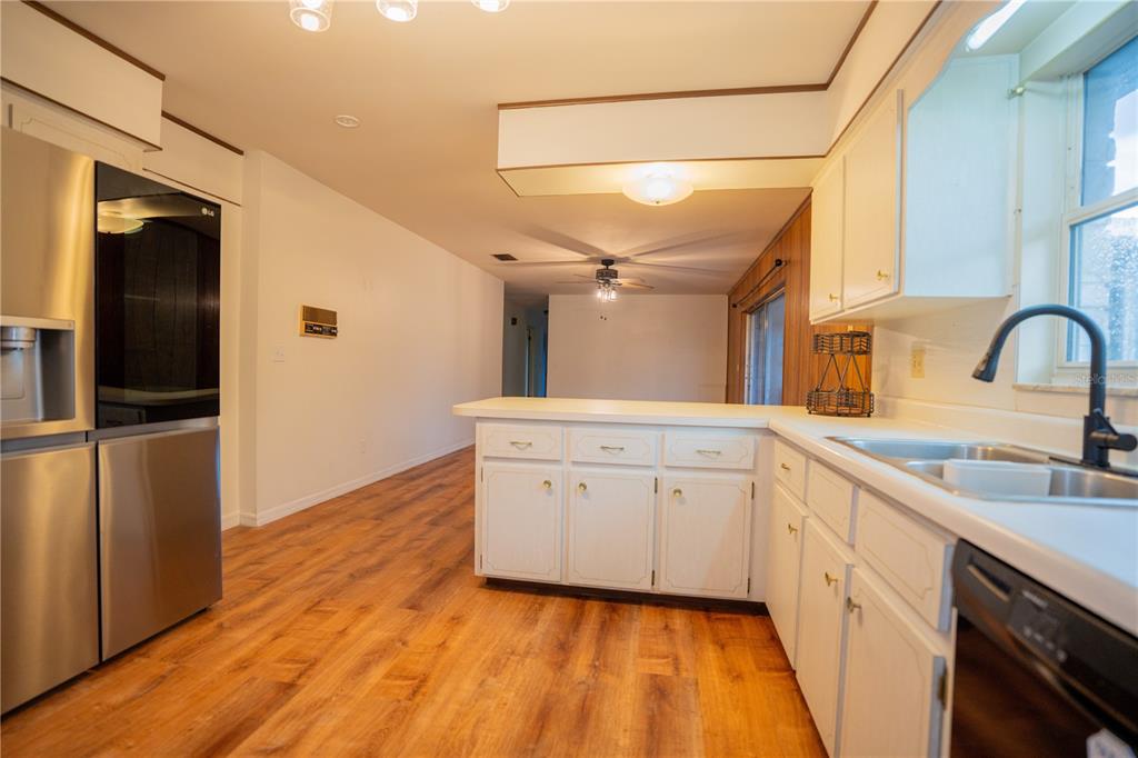 417 L Lanier Road Fort Meade, FL 33841 - Photo 22 of 36 a kitchen with a sink cabinets and wooden floor