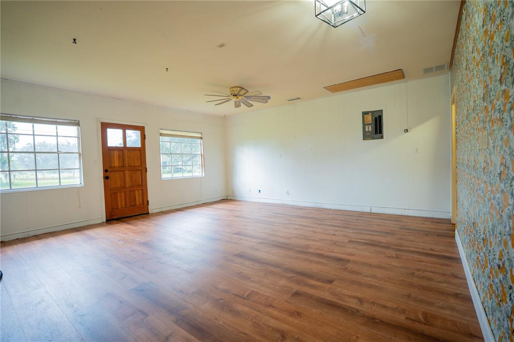 417 L Lanier Road Fort Meade, FL 33841 - Photo 27 of 36 an empty room with wooden floor and windows