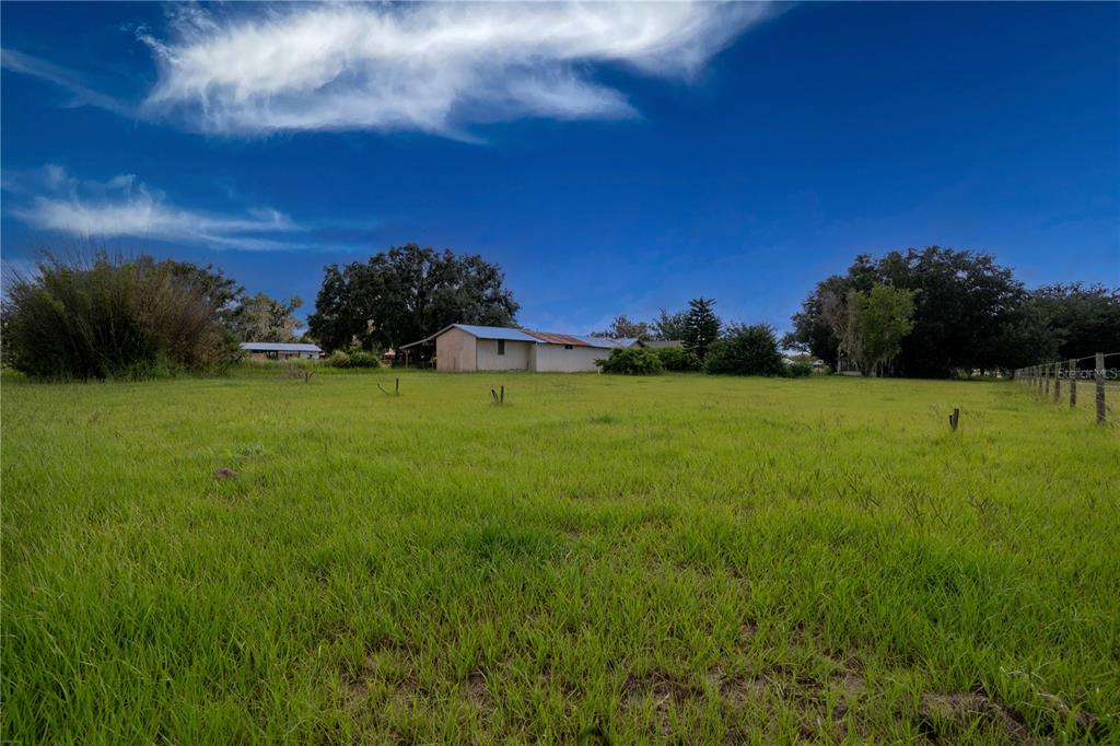 417 L Lanier Road Fort Meade, FL 33841 - Photo 33 of 36 a view of a grassy field with an trees