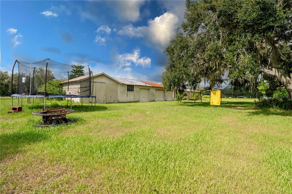 417 L Lanier Road Fort Meade, FL 33841 - Photo 34 of 36 a backyard of a house with table and chairs