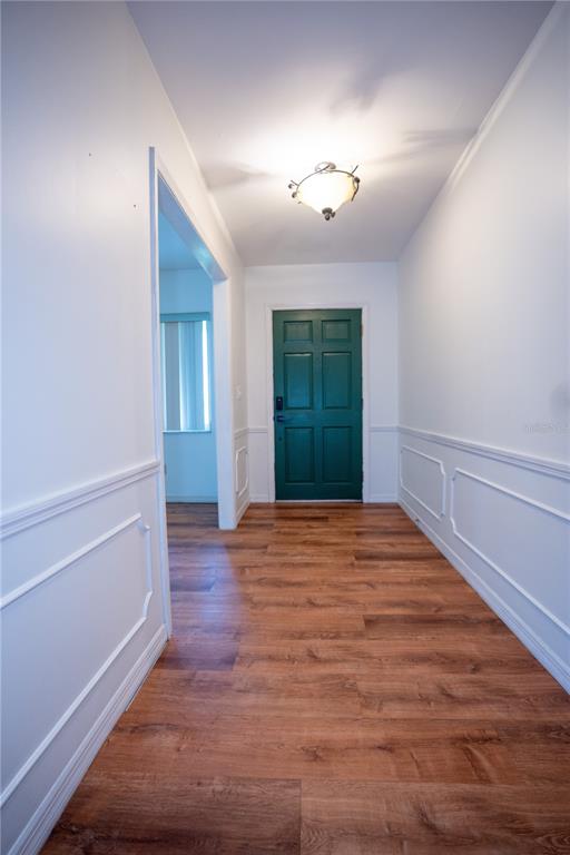 417 L Lanier Road Fort Meade, FL 33841 - Photo 5 of 36 an empty room with wooden floor and windows