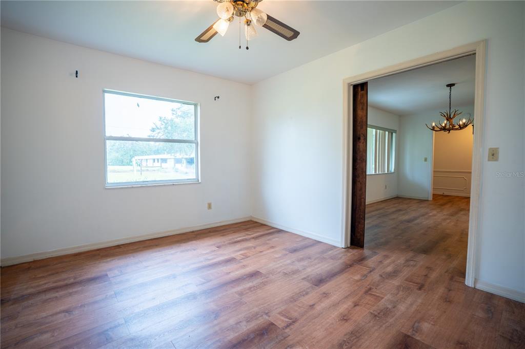 417 L Lanier Road Fort Meade, FL 33841 - Photo 8 of 36 wooden floor in an empty room with a window