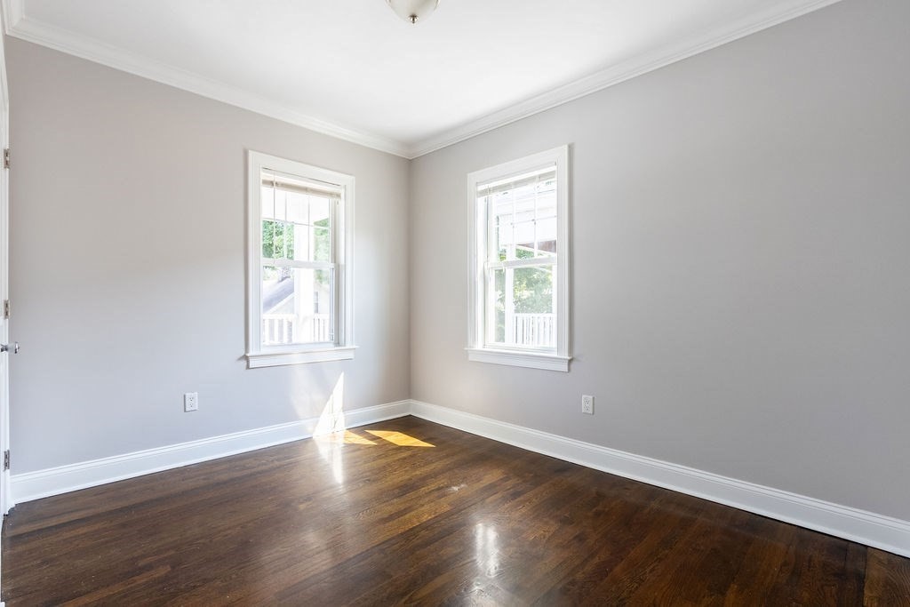 40 Stellman Road, Unit 33 Boston, MA 02131 - Photo 11 of 20 an empty room with wooden floor and windows