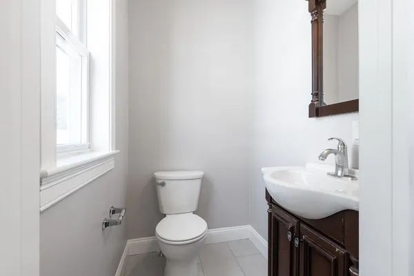 a bathroom with a sink toilet and mirror