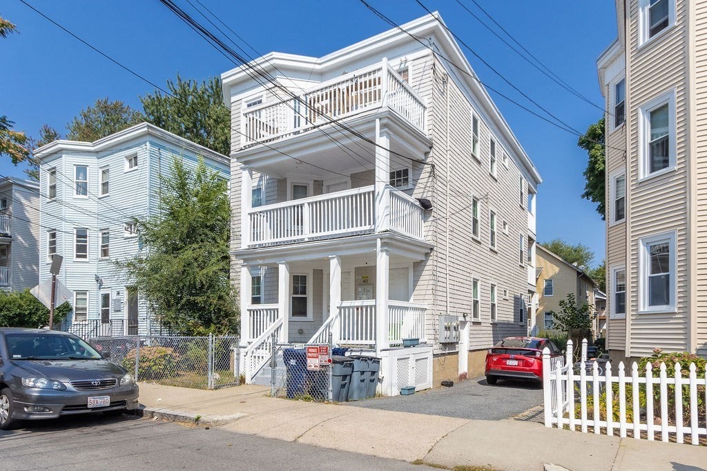 40 Stellman Road, Unit 33 Boston, MA 02131 - Photo 15 of 20 a view of a white building among the street with parked cars