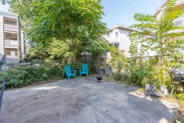 a view of a house with a tree and a yard