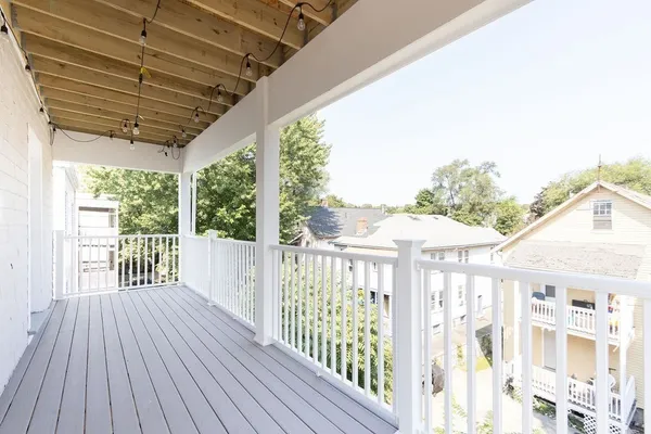 a view of a porch with wooden floor and outdoor space